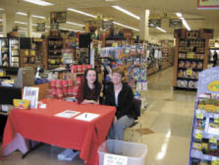 Cascade Team members Tonya Eliason and Sally Whitson staff their table at the North Bend QFC last month during Operation Crayon Drive