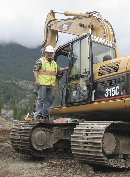 North Bend builder John Day climbs into an earthmover at his new Tannerwood development