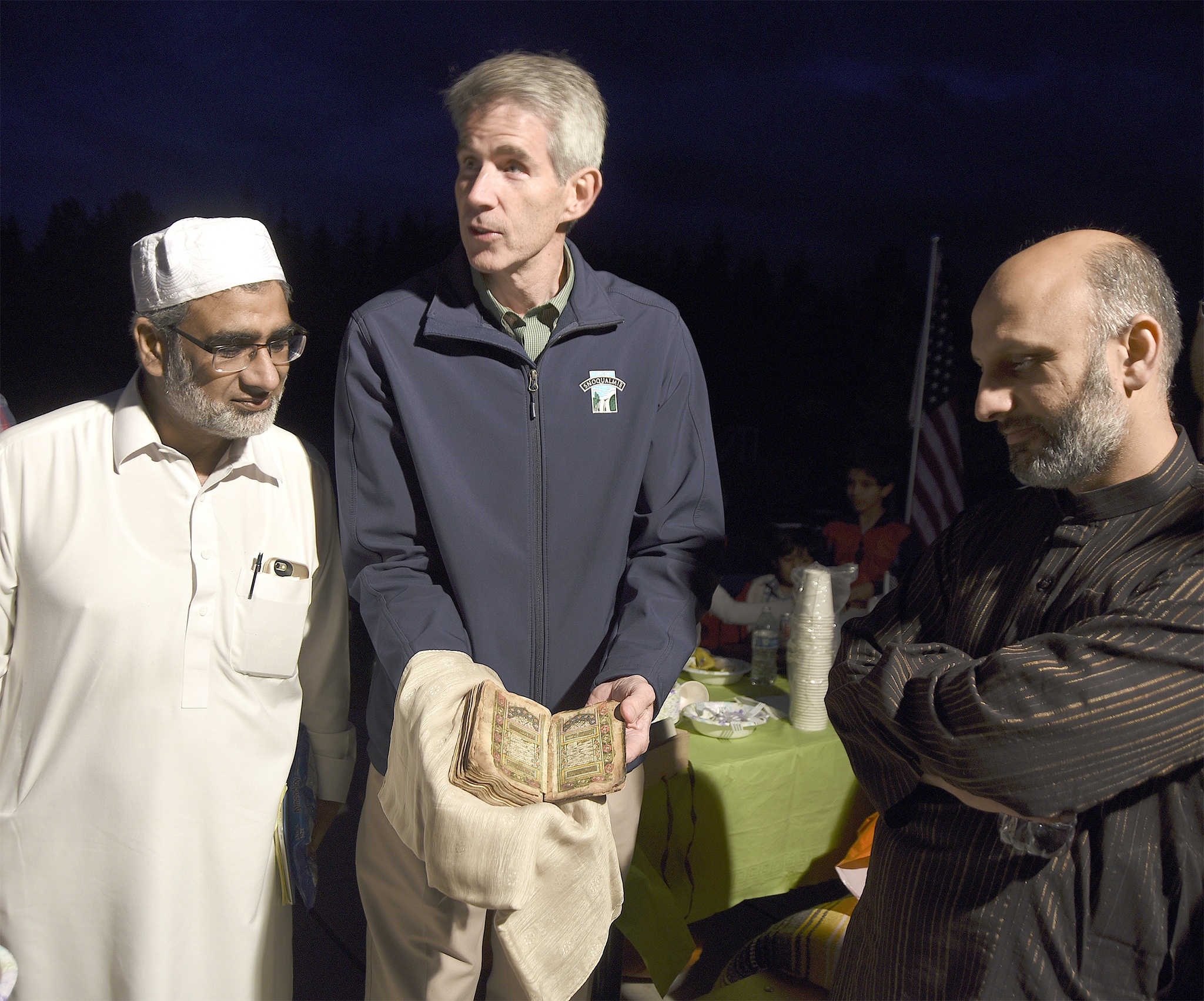 Snoqualmie Mosque Imam Khalid Masude admires the centuries-old Quran. Carol Ladwig/Staff Photo