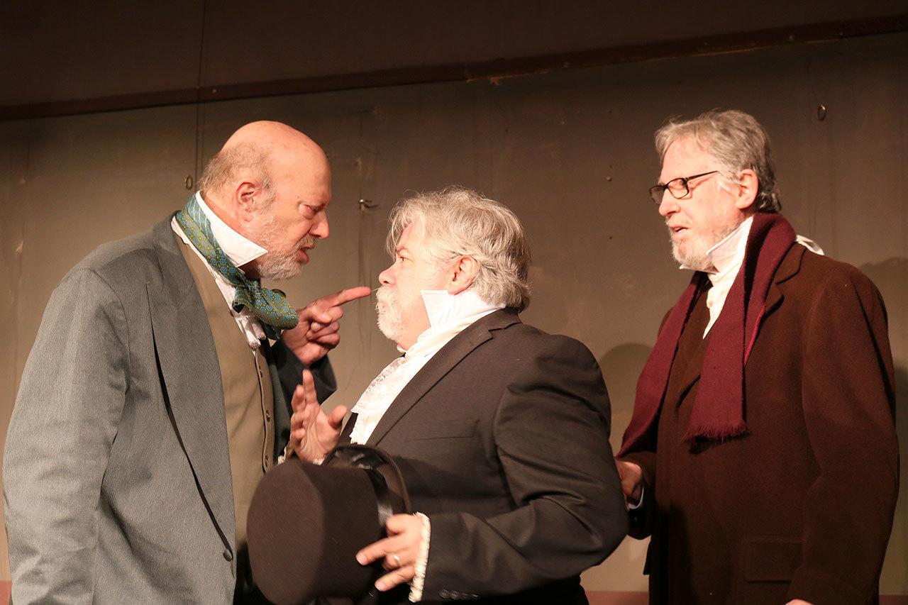 Scrooge, played by Gary Schwartz, angrily tells the two solicitors, played by Craig Ewing and Robert J. Lee, to get out of his office. (Evan Pappas/Staff Photo)