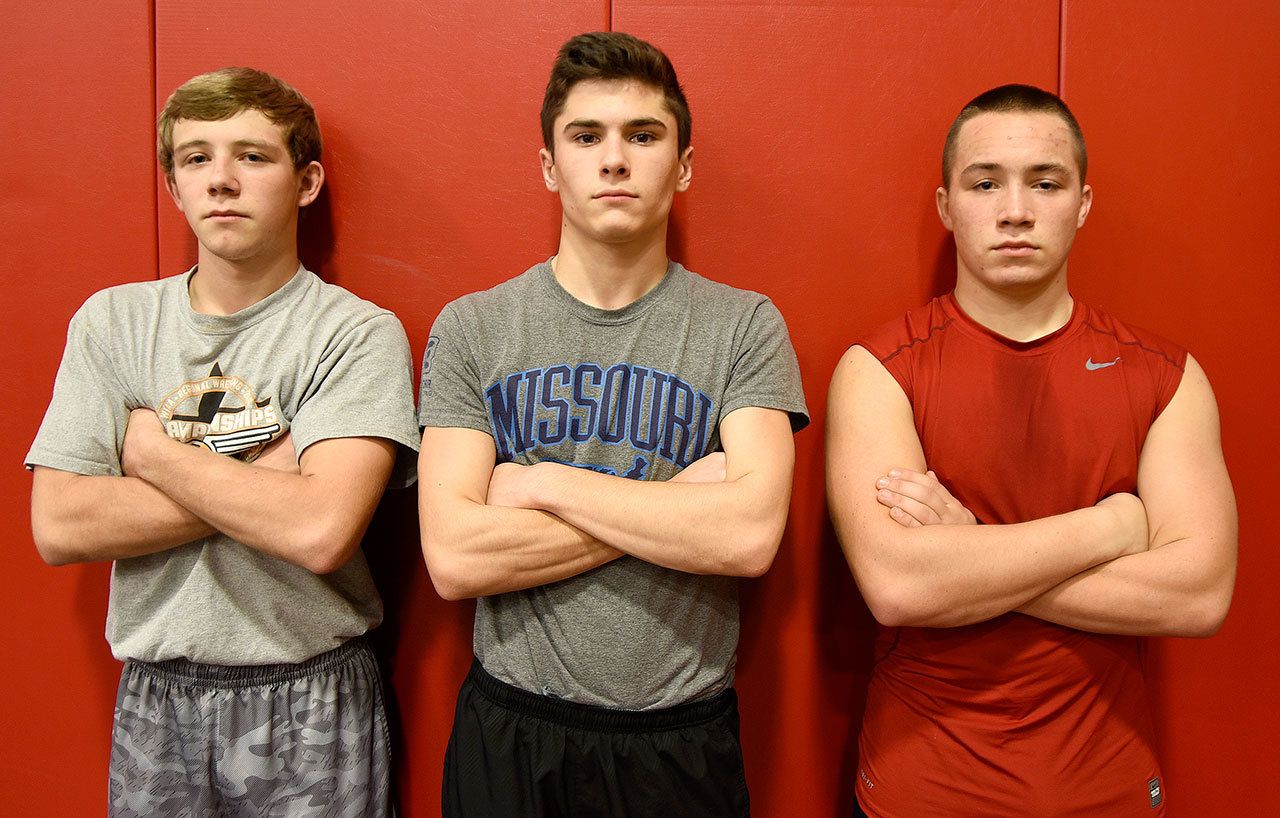 Carol Ladwig/Staff Photo                                Seniors on the Cedarcrest wrestling team pictured from left are Billy Hinzman, Parker McBride and Jonathan Castle.