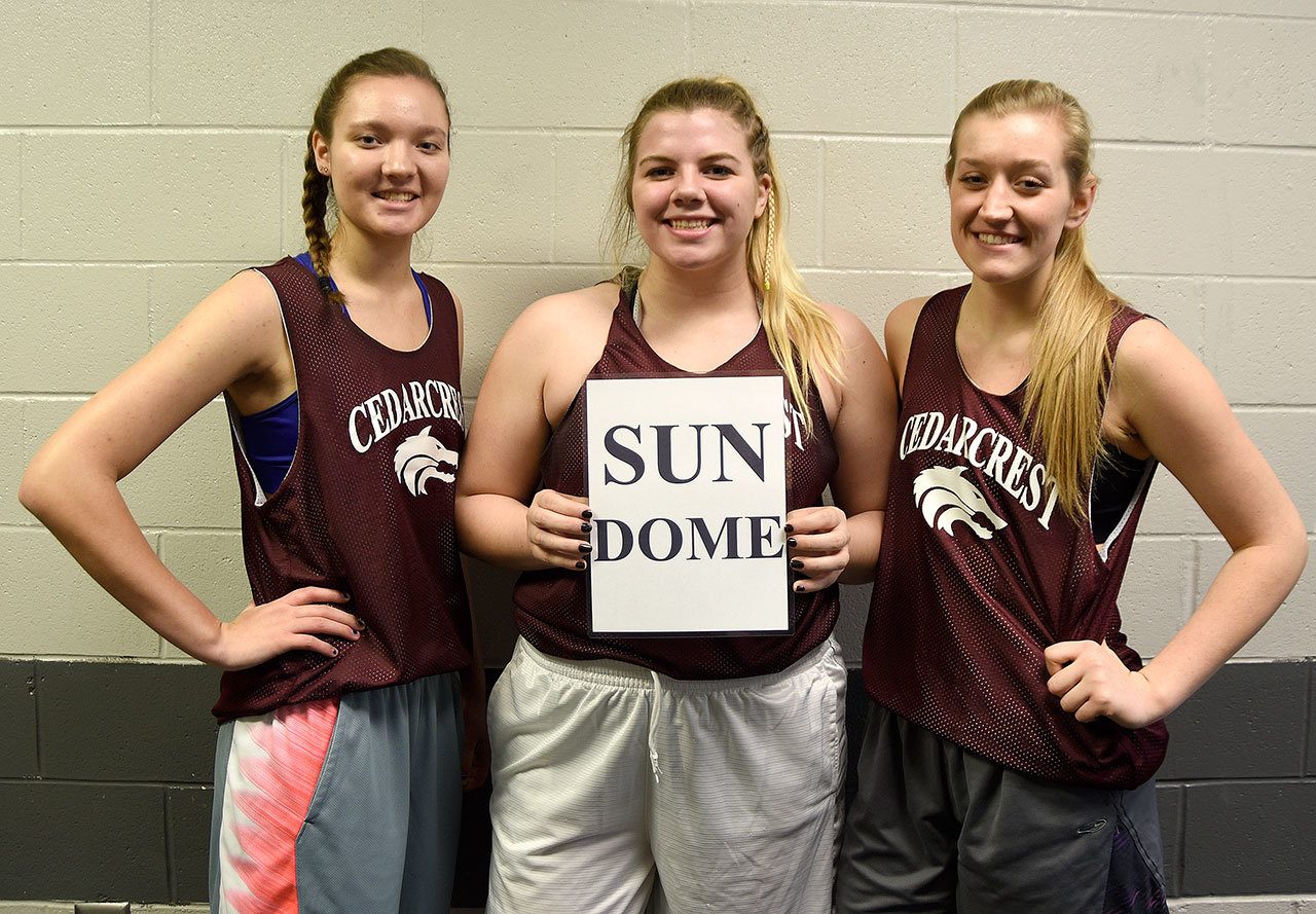 Carol Ladwig/Staff Photos                                 Team captains for the second year running for the Cedarcrest girls basketball team are, from left, Kennedy Howell, Meredith Burke holding the team’s Sun Dome sign, and Mieke VanEss.