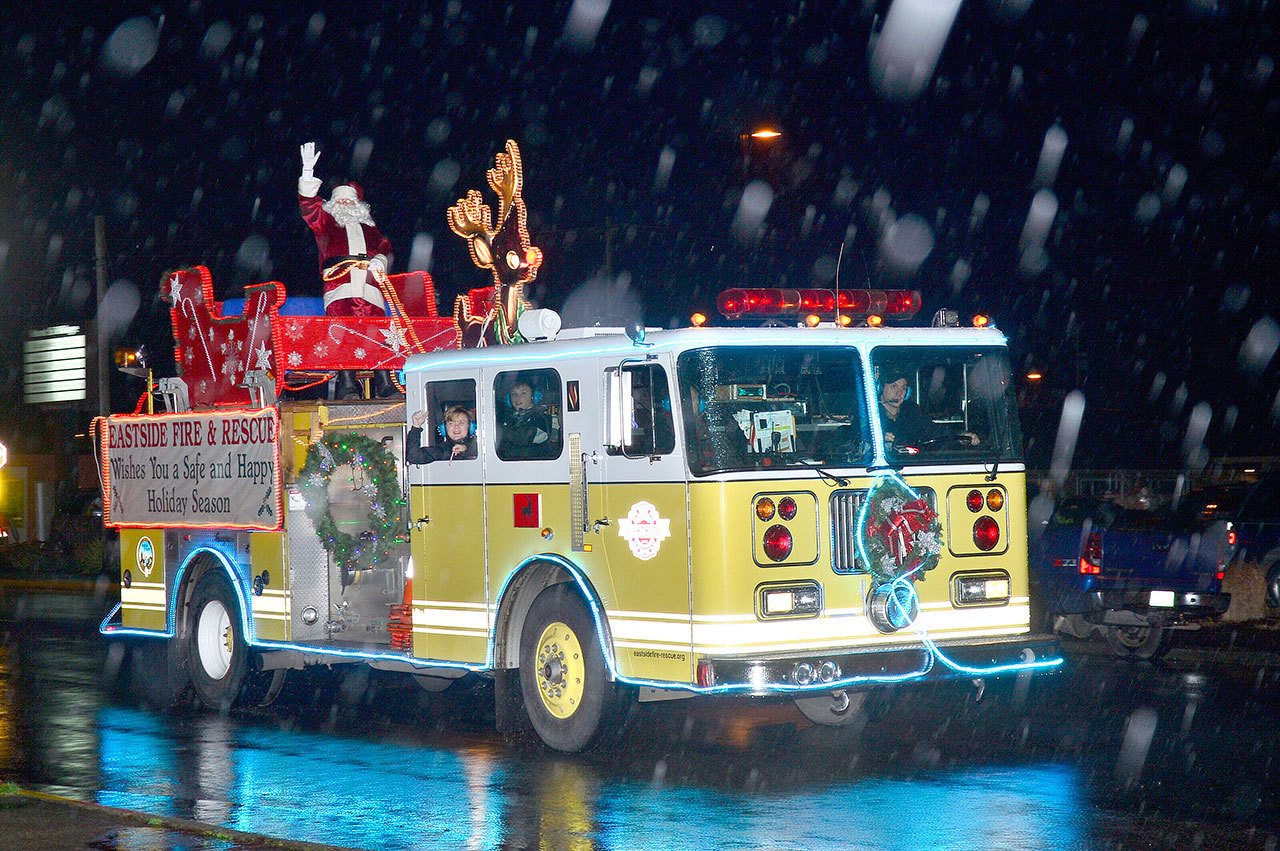 Santa arrived at the North Bend tree lighting Saturday, Dec. 3, riding on the Eastside Fire & Rescue Reindeer Engine.                                Mary Miller Photo