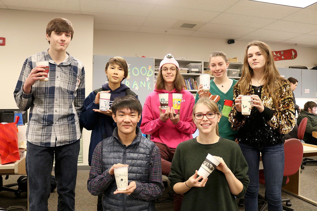 The eight Mount Si High School students who designed the custom coffee sleeves. From left, back row: Dawson Bolen, Natalie Ng, Brandon Roberts, Delany Edwards, Lillian Nordbey. Front row: Jasper Chee and Emily Creed. (Evan Pappas/Staff Photo)