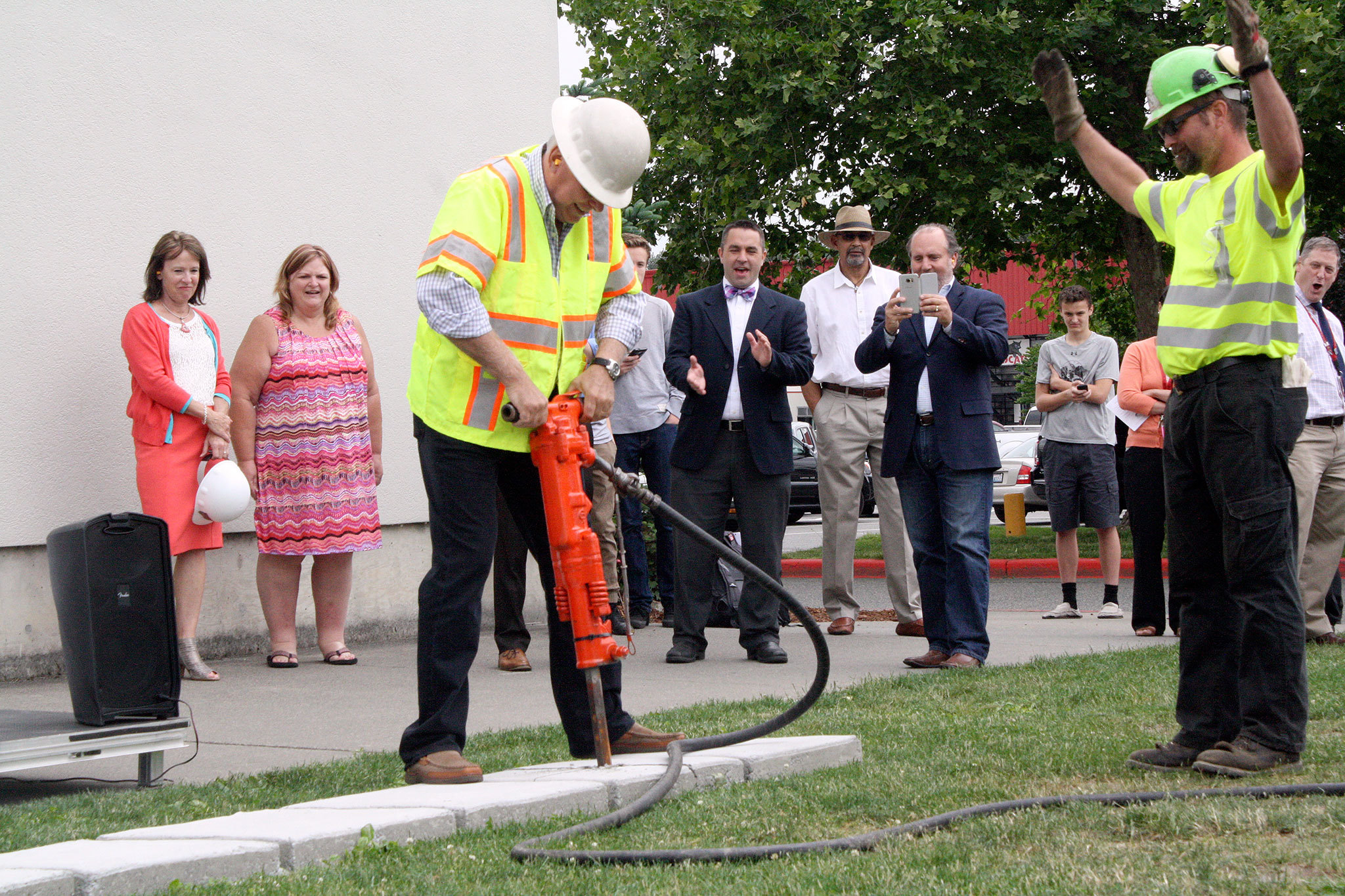 Geoff Doy, president of the Snoqualmie Valley School Board, uses a jack hammer to break the ground at Mount Si High School June 8, on a multi-year remodel and rebuild of the facility.                                Evan Pappas/Staff Photo