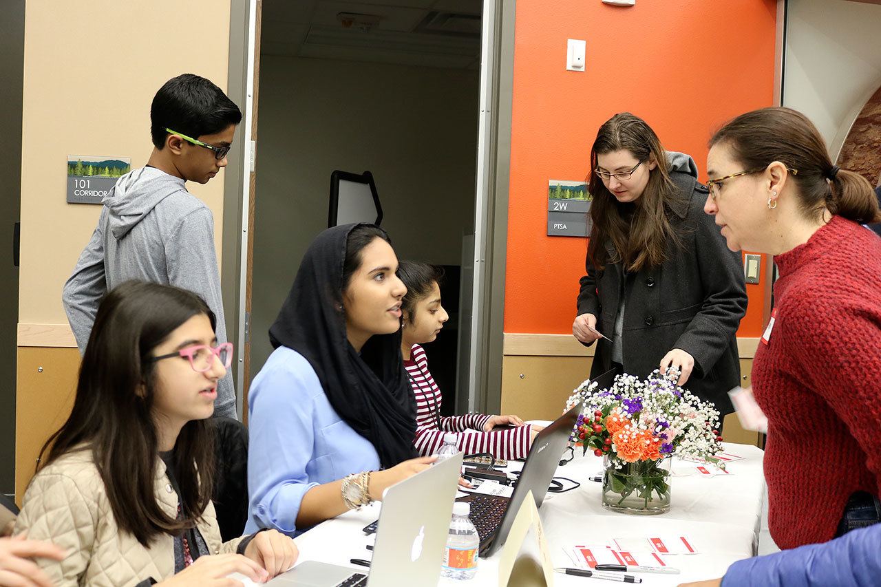 From left: Soha Fatima, Mariam Mohammad and Sana Qasim, check in participants before the presentations begin. (Evan Pappas/Staff Photo)