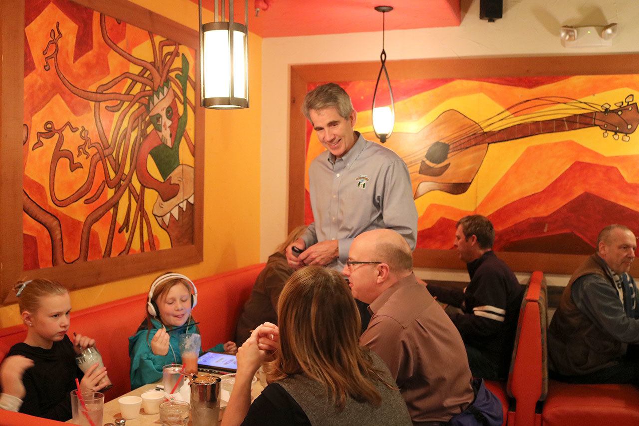 Snoqualmie Mayor Matt Larson chats with a family eating at Ana’s during the YMCA’s fundraiser last Tuesday. (Evan Pappas/Staff Photo)