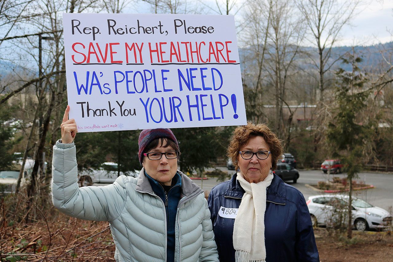From left, Marion Kee of Redmond and Sharon Kay of Kent befriended one another at the rally after coming together to discuss their concerns for health care and immigration in the United States. Kee, who twice survived cancer, said that the Affordable Care Act has made it possible for her to have health care.
