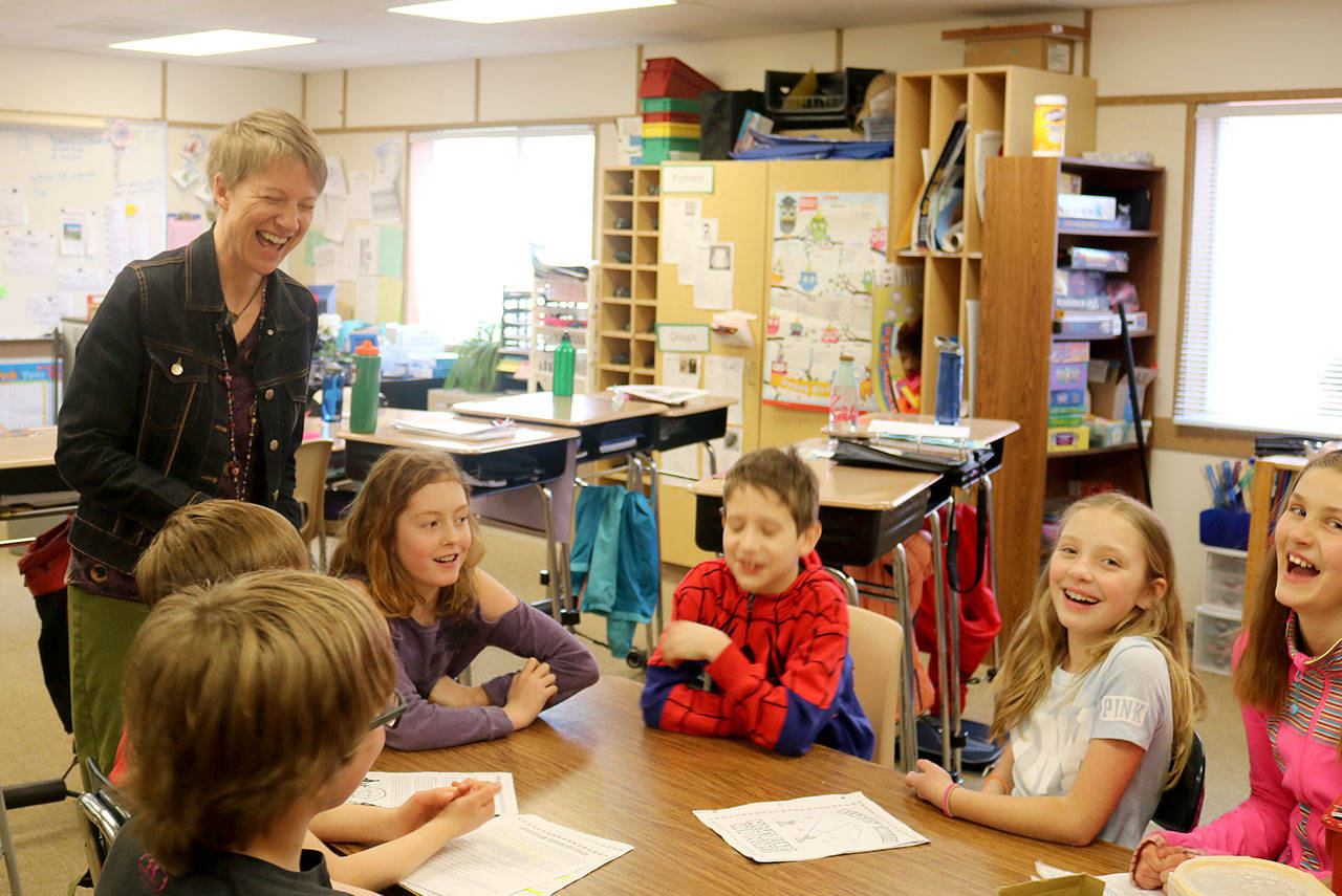 Emily Larson laughs with her students during a class activity. (Evan Pappas/Staff Photo)