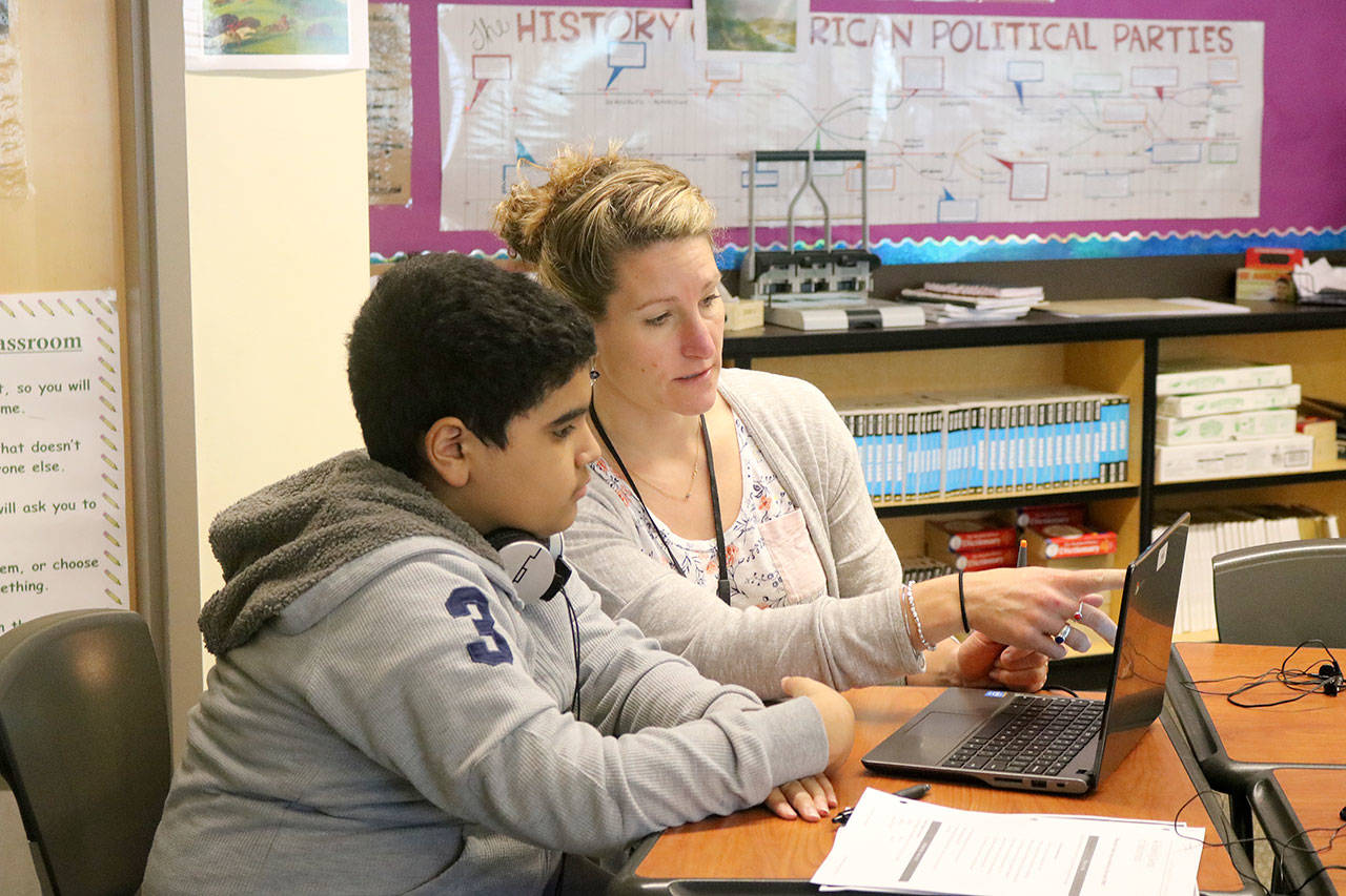 Emily Rourke helps a student with an assignment in her history class. (Evan Pappas/Staff Photo)
