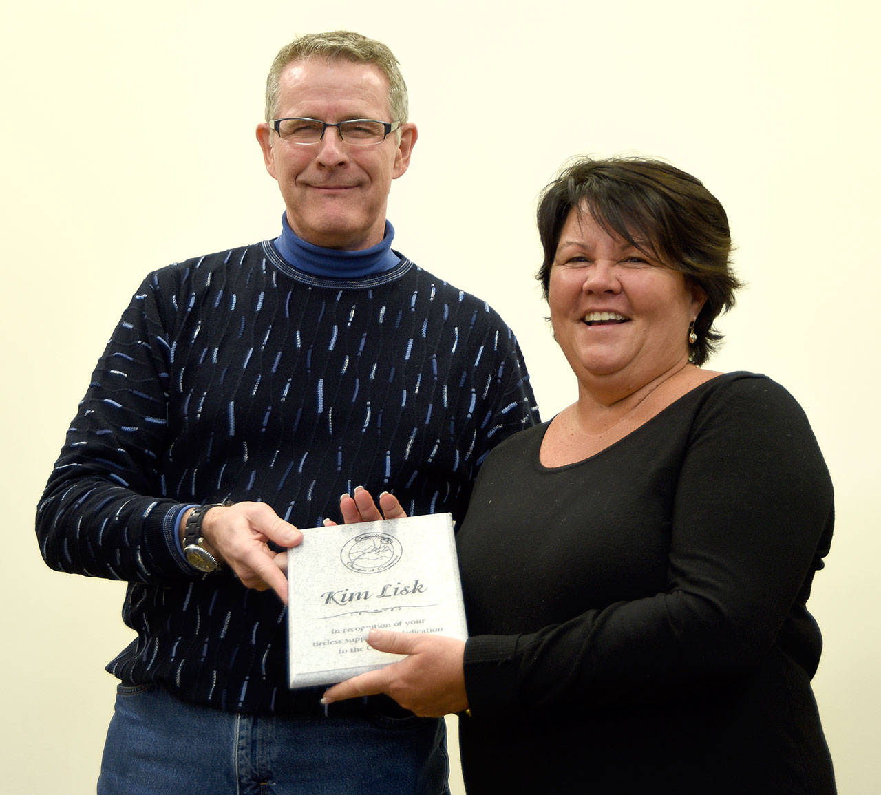 Carnation Chamber of Commerce President Eric Torrison presents Kim Lisk with a plaque March 16, in appreciation of her many volunteer efforts in support of the Carnation community.                                Carol Ladwig/Staff Photo