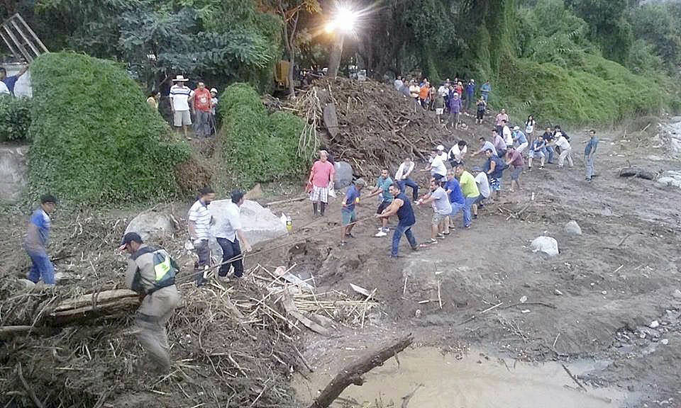 Citizens in Chaclacayo, Peru, work together to clear away debris from damage caused by flooding and mudslides. (Courtesy Photo)