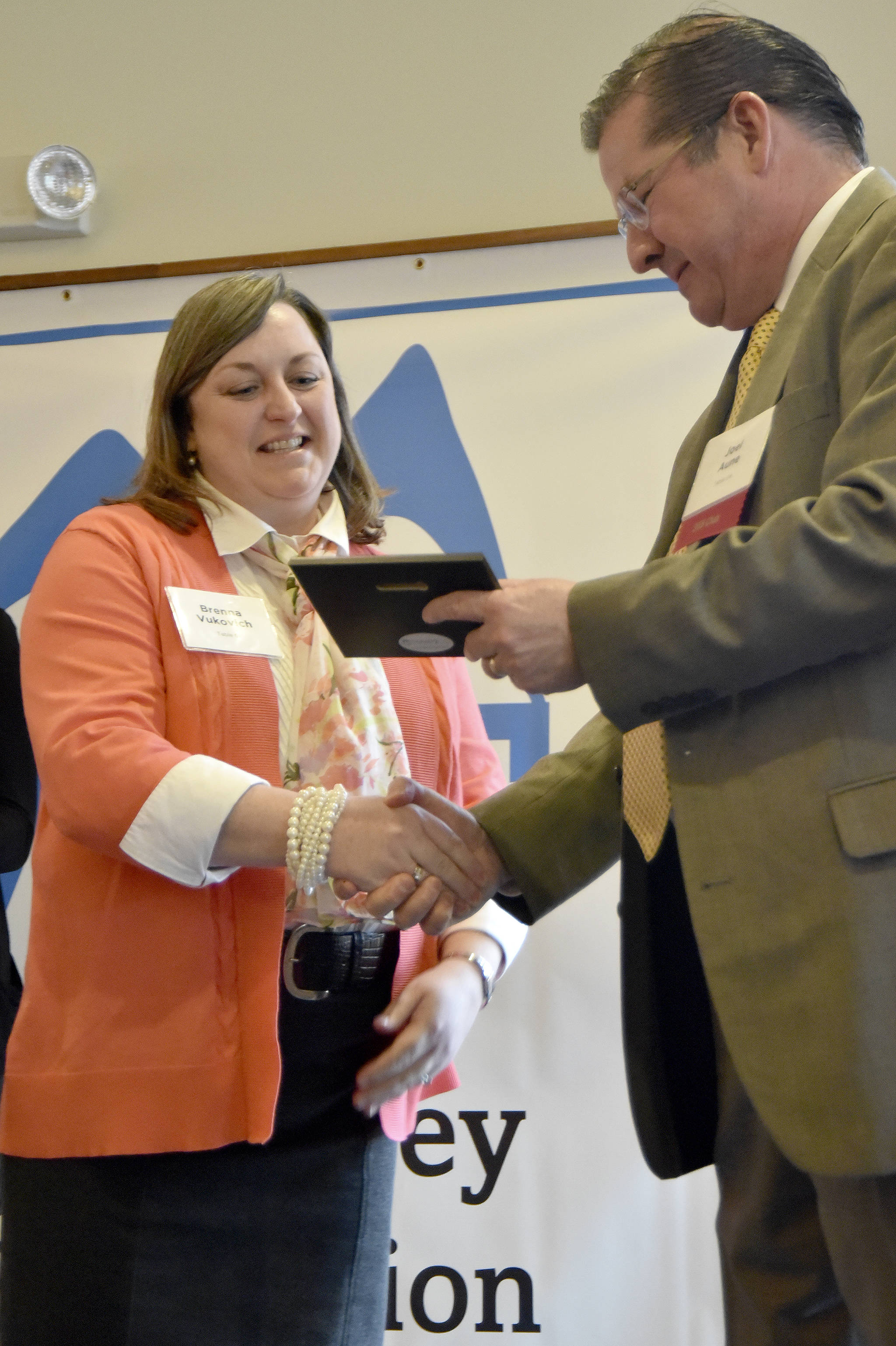 Brenna Vukovich accepts the Classified Educator of the Year award from Snoqualmie Valley School District Superintendent Joel Aune March 23 at the Snoqualmie Valley Schools Foundation luncheon. Carol Ladwig/Staff Photo