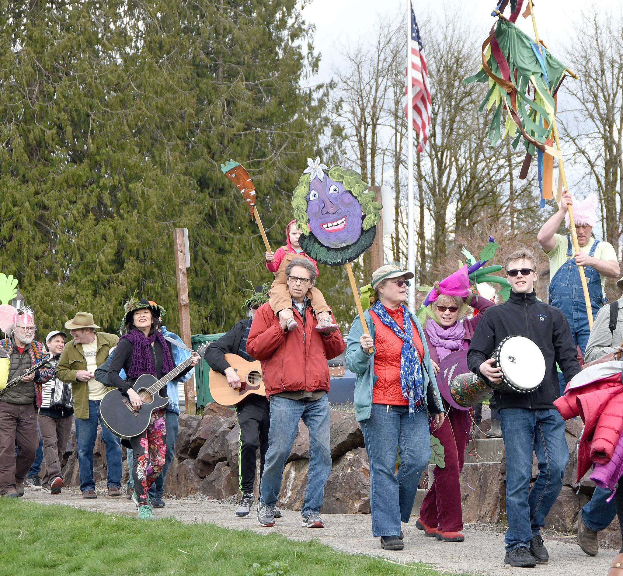 Singing and playing “I heard it through the grapevine,” participants in the March of the Vegetables parade arrived in a festive group for the post-parade celebration in Duvall’s Depot Park.                                Carol Ladwig/Staff Photo