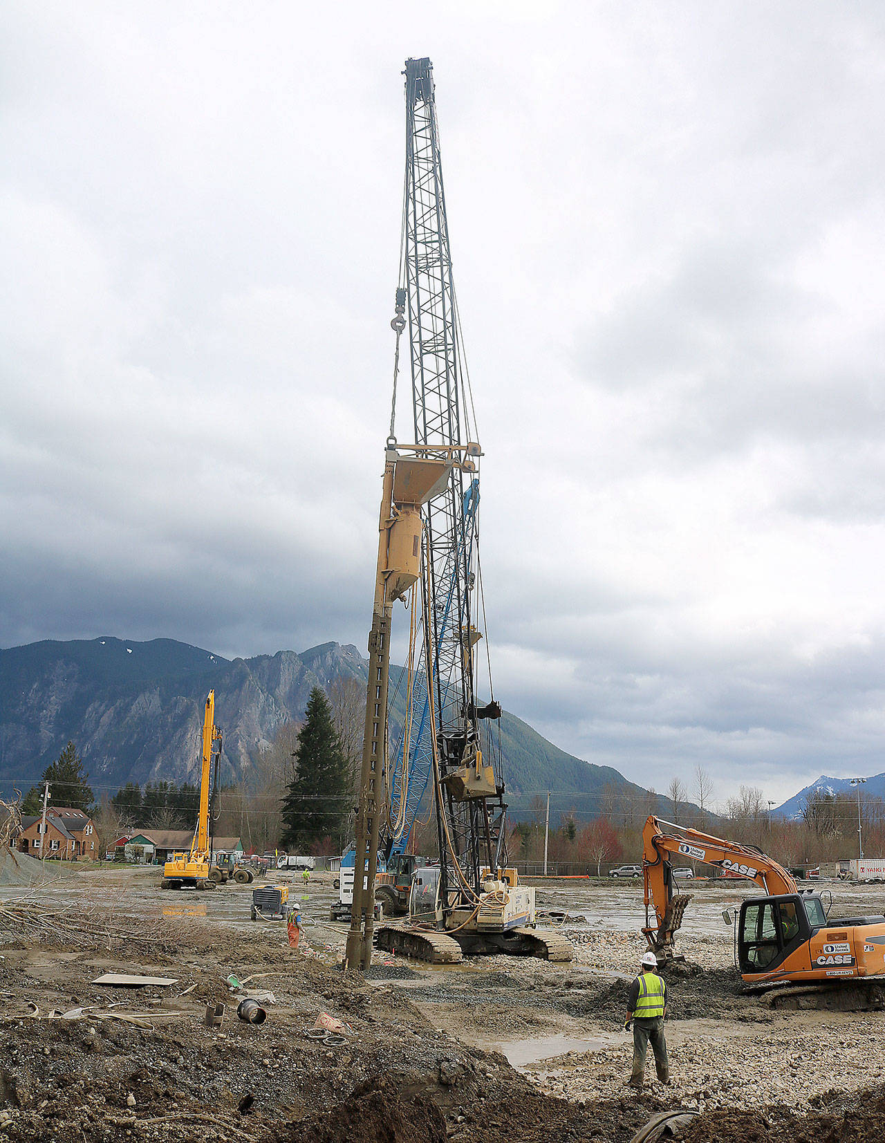 Compressed air spurts from a 35-foot hole drilled in front of Mount Si High School. The crane operator used the air to compress the soil and stones being fed into the column, designed to stabilize the new school in an earthquake. (Evan Pappas/Staff Photo)
