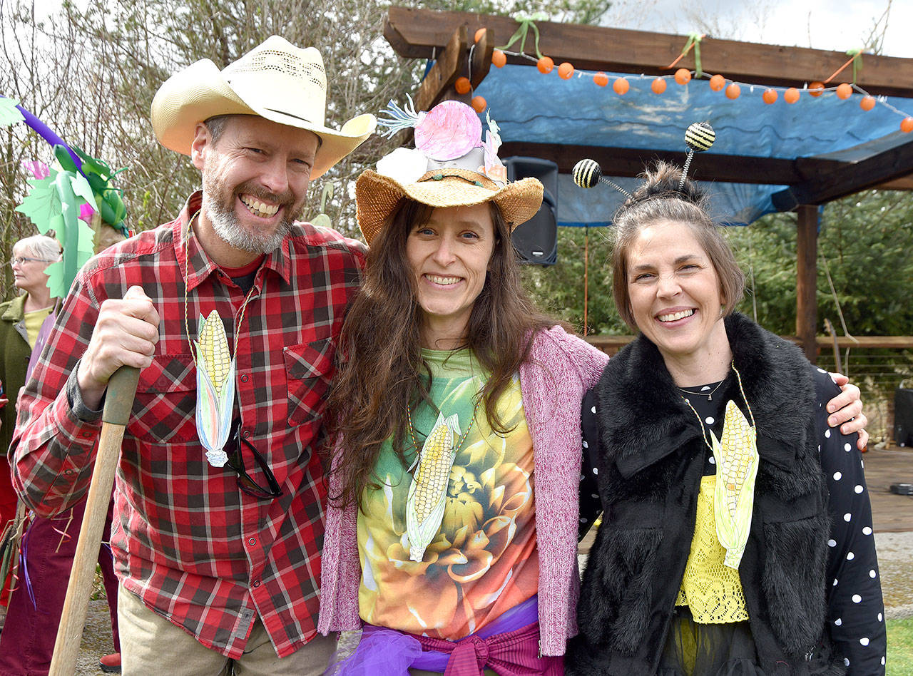 Dressed as farmers, flowers, vegetables and pollinators, Doug Klaiber, Beth Burris and Clare Chapple enjoyed the March of the Vegetables.                                Carol Ladwig/Staff Photo