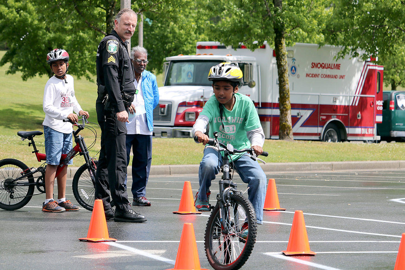 Snoqualmie Police, pictured here overseeing the 2016 Tanner Jeans Bike Rodeo, will be conducting a child-abduction training exercise on Snoqualmie Ridge all week.                                Evan Pappas/File Photo