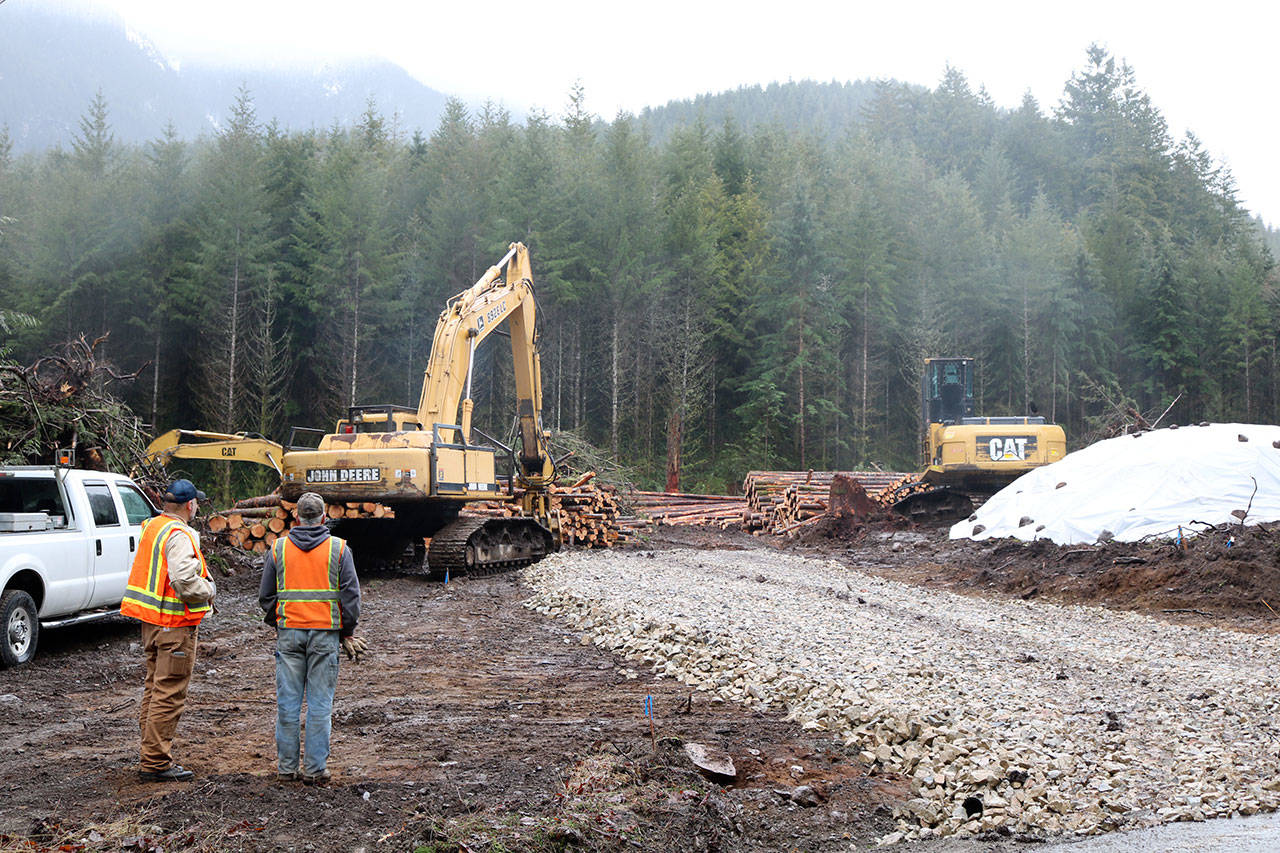 Workers look over the project site of the new Teneriffe trailhead this spring, when the project got underway. The new parking lot, with capacity for about 100 cars, and connecting trails are expected to be complete by July 1. (Evan Pappas/Staff Photo)