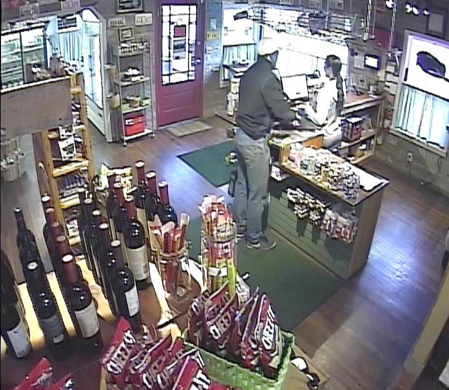 This surveillance photo shows the Friday night robbery of the Cascade Golf Course shop in progress.                                (Courtesy Photo)