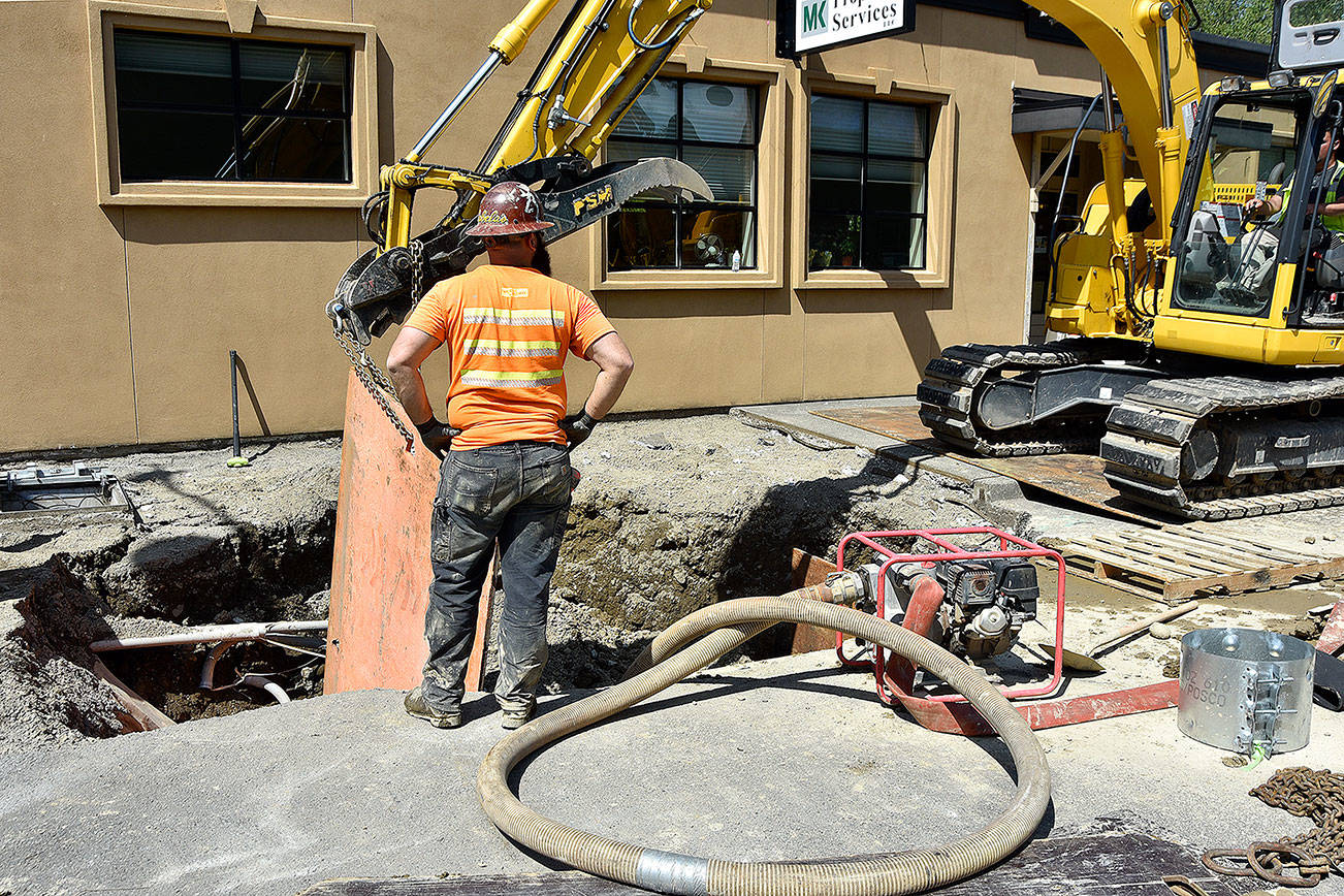 Workers use metal plates to shore up their work area underground earlier this week, as they get ready to repair a stormwater pipe damaged May 4.                                Carol Ladwig/Staff Photo