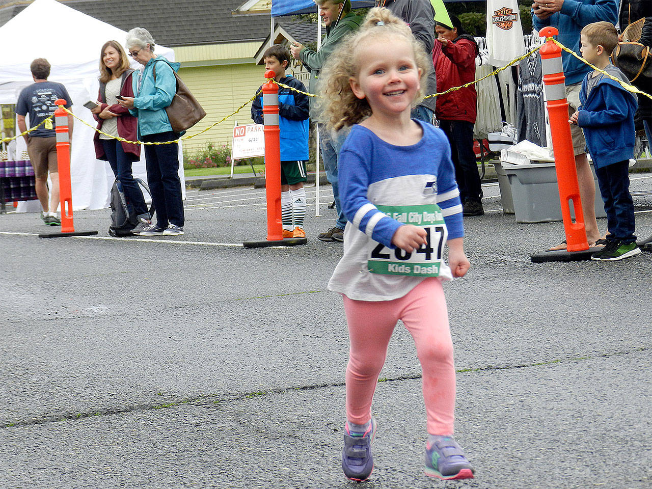One of the youngest 2016 Fall City Day racers smiles as she heads to the finish line.                                William Shaw/File Photo