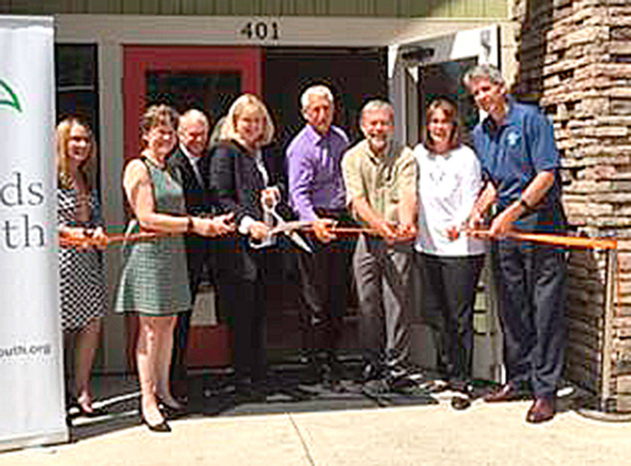 Cutting the ribbon on the new North Bend office of Friends of Youth are, from left: Gena Palm, Director of Youth and Family Services, Friends of Youth; King County Councilmember Kathy Lambert; Bill Savoy, Board Chair, Friends of Youth; Terry Pottmeyer, CEO, Friends of Youth; Congressman Dave Reichert; Ken Hearing, Mayor of North Bend; Jennifer Larson, SanMar; and Matt Larson, Mayor of Snoqualmie.                                Courtesy Photo