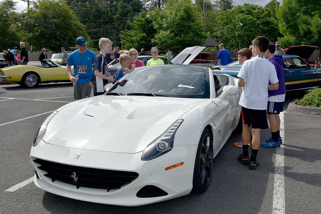 Kids check out a Ferrari at the Mount Si Lions Club car show. (Carol Ladwig/Staff Photo)
