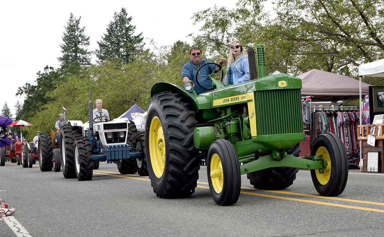 Tractors parade down S.R. 202 for Fall City Day. (Carol Ladwig/Staff Photo)