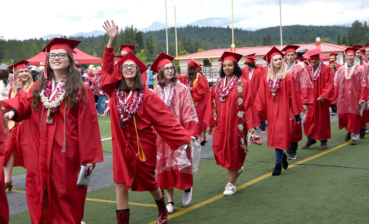 Seniors file into Mount Si Stadium and wave at family members in the audience at Mount Si High School&rsquo;s commencement ceremony Friday.                                Carol Ladwig/Staff Photo