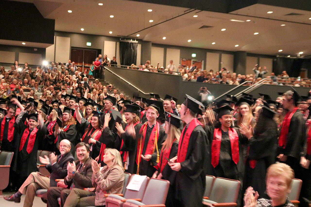 The crowd cheers as the students turn their tassels to mark their graduation.                                (Evan Pappas/Staff Photo)