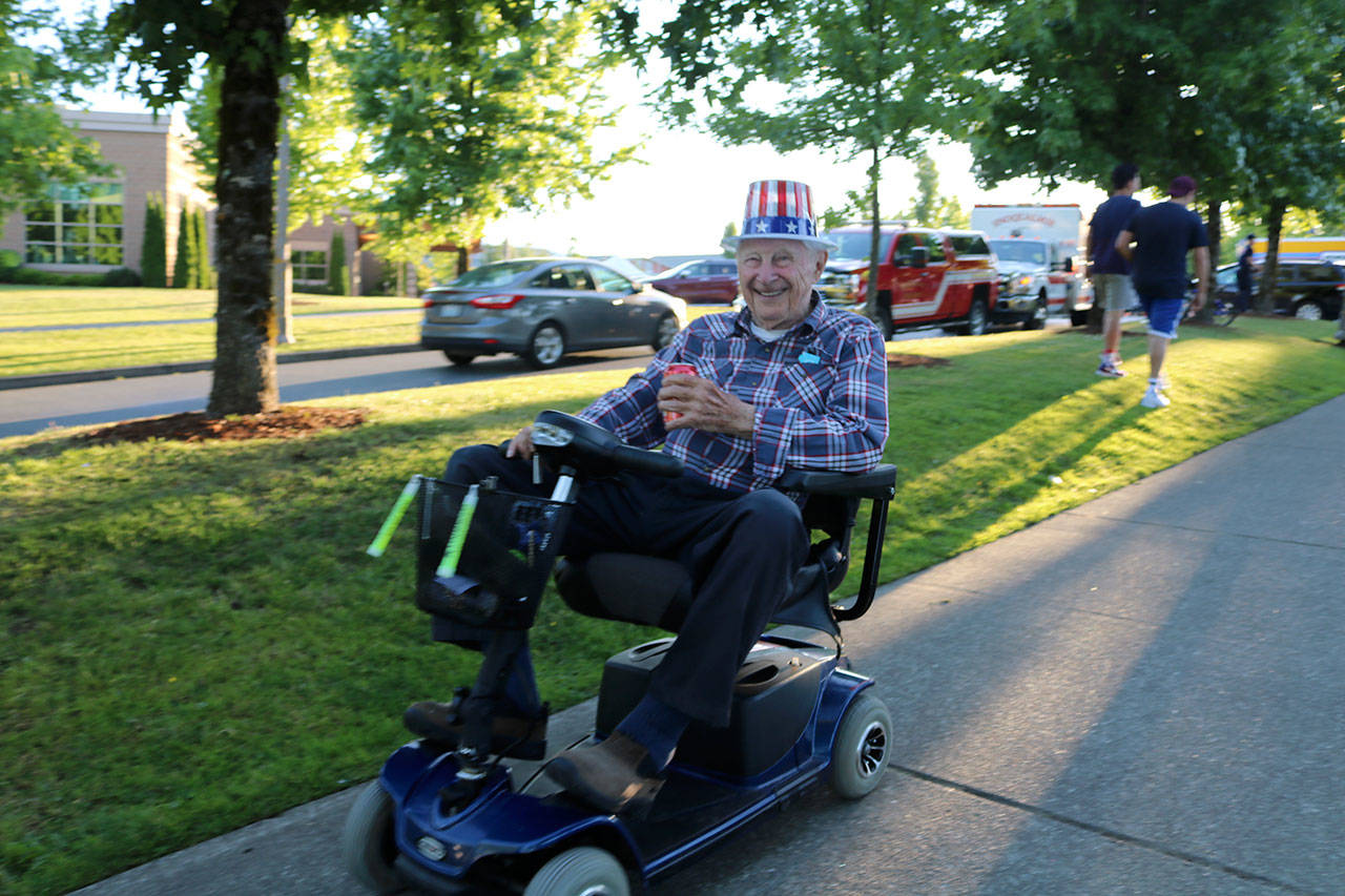 Bob Murray drives along the sidewalk at Community Park before the fireworks show. (Evan Pappas/Staff Photo)