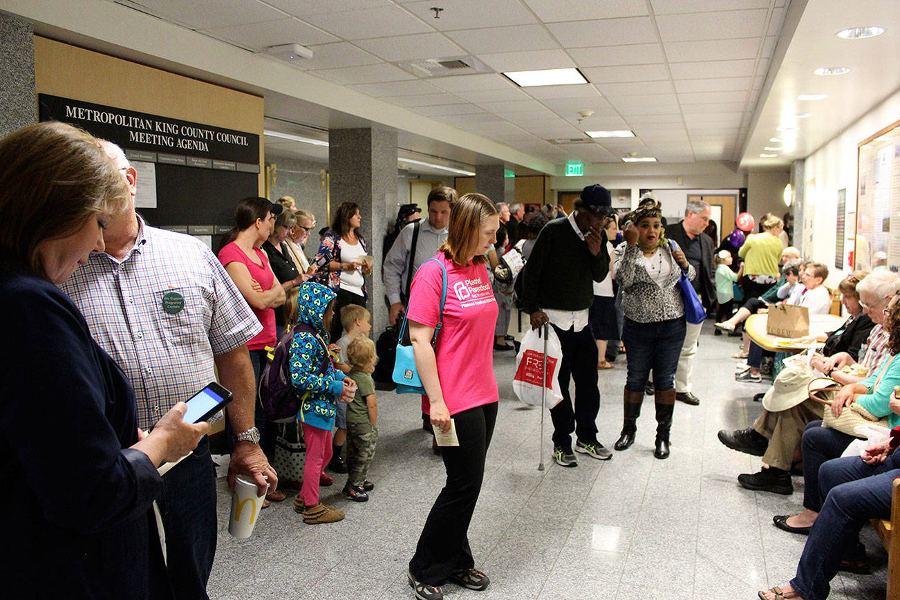 Attendees wait outside the King County Council Chambers at the Board of Health hearing on July 20.                                (Photo by Sara Bernard)