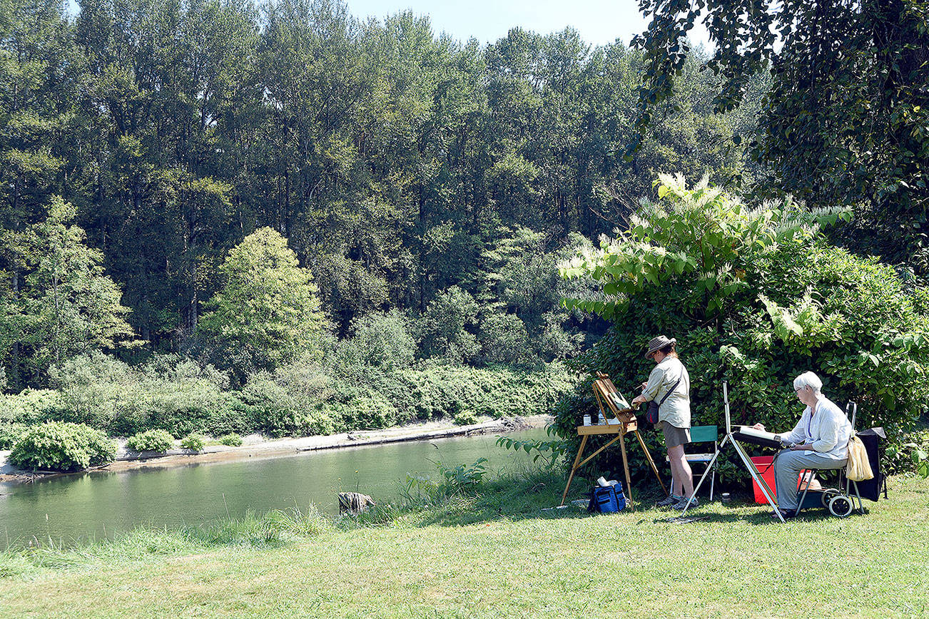 Painters Deborah Knetzger of Kirkland and Charlotte Scherer of Issaquah create art in Sandy Cove Park at the 2016 Plein Air Paint Out.                                (Carol Ladwig/File Photo)