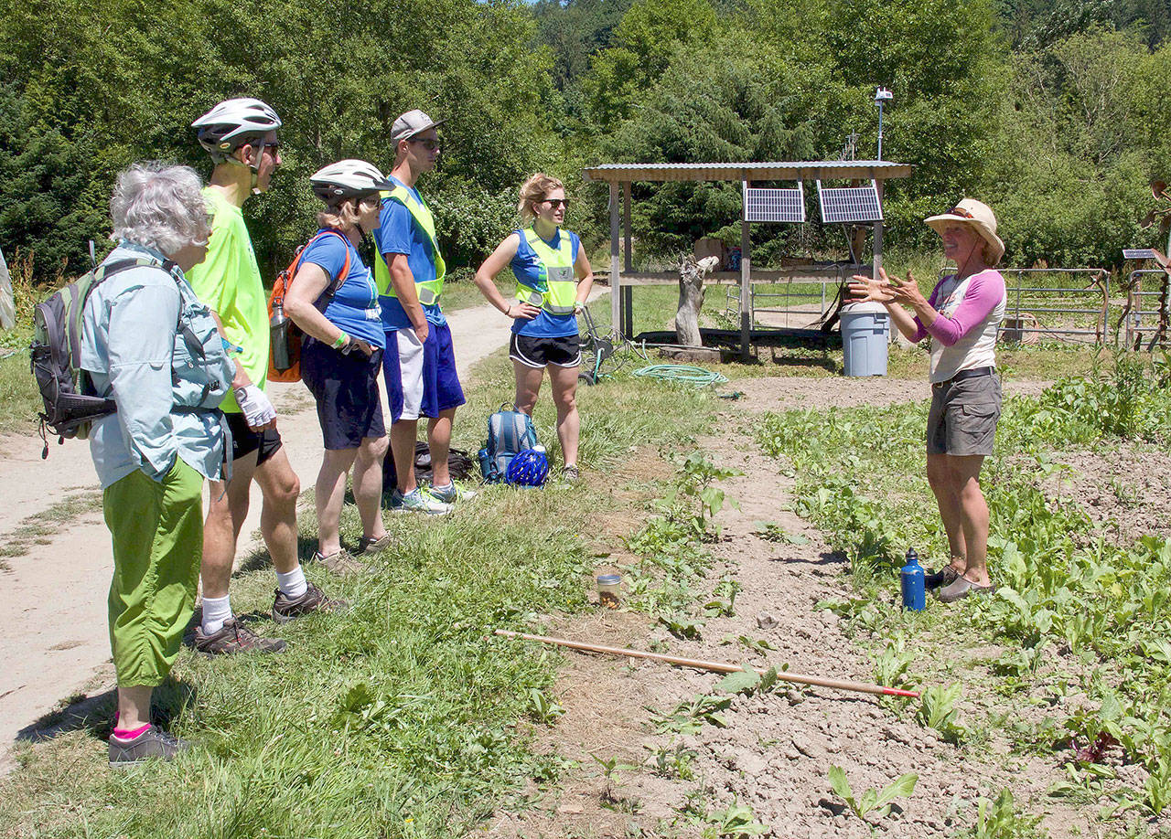 At a stop at Hearth Farm, Rails to Trails participants learn about the farm’s sustainability efforts.                                Photo courtesy of Ray Lapine