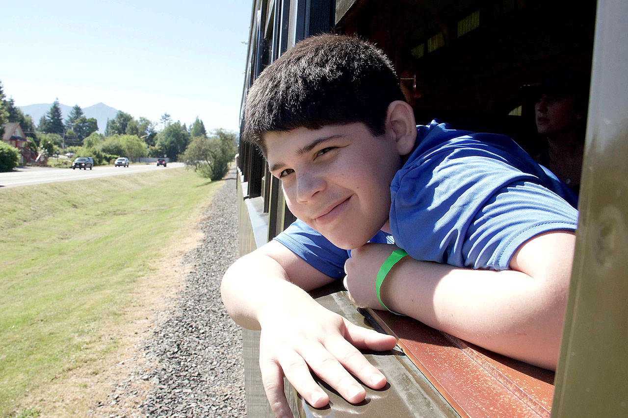 Vincent Arellano of Snoqualmie, looks out the window on the Rails to Trails train ride June 24. He was on the expedition with his father, Mike.                                Photo courtesy of Ray Lapine
