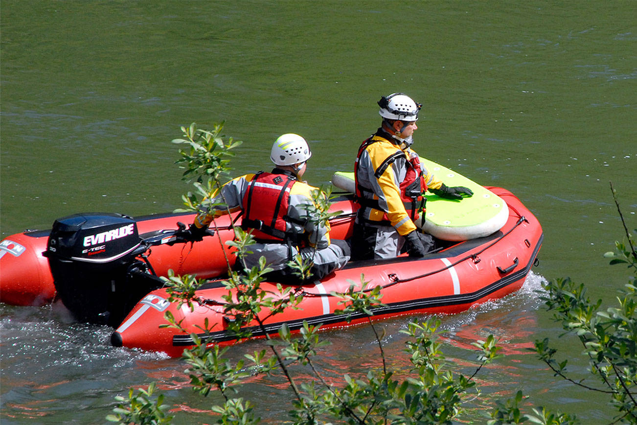 A swiftwater rescue boat searches the river in this 2014 file photo.