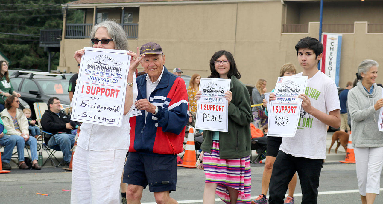 Snoqualmie Valley Indivisibles members march along North Bend way during the parade.                                (Evan Pappas/Staff Photo)