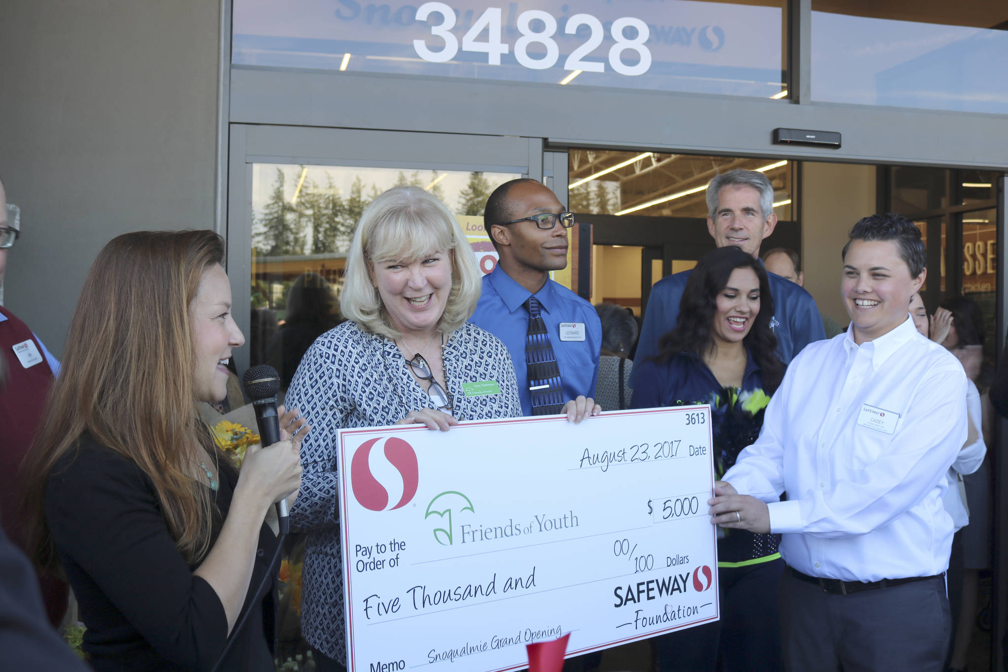 Terry Pottmeyer, CEO of Friends of Youth, receives a $5,000 donation from the Safeway Foundation at the grand opening event.                                (Evan Pappas/Staff Photo)
