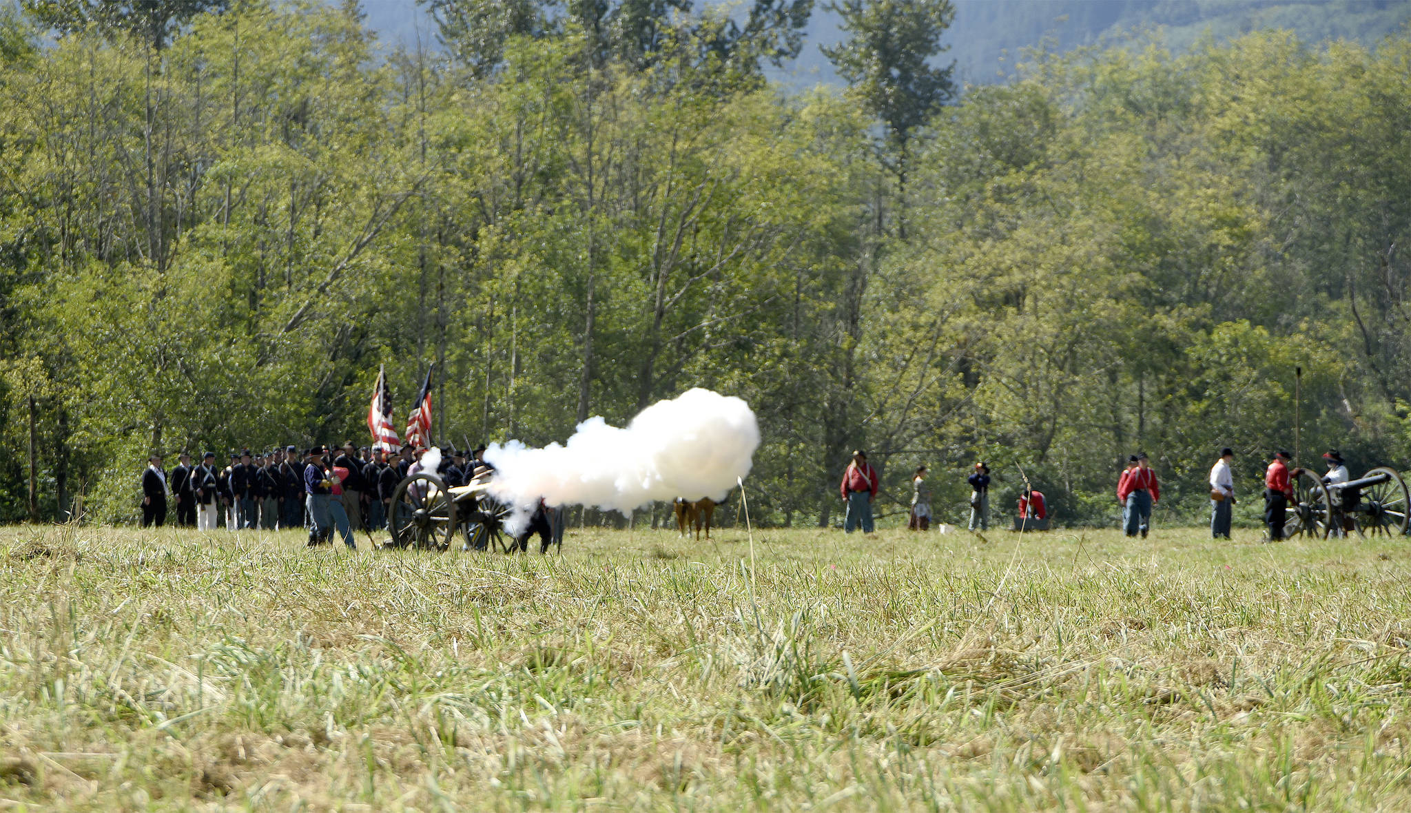 A Union artillery cannon fires at the enemy at the start of a 2016 Civil War battle re-enactment at Meadowbrook Farm.