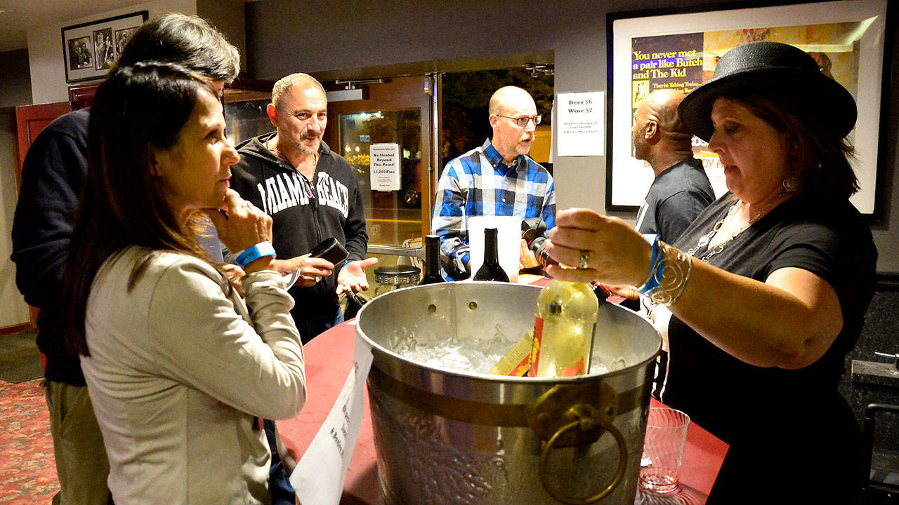 Blues Walk volunteer Carol Montelone-Whiteside serves thirsty customers at the North Bend Theatre during Saturday’s Blues Walk. (Photo courtesy of Mary Miller)