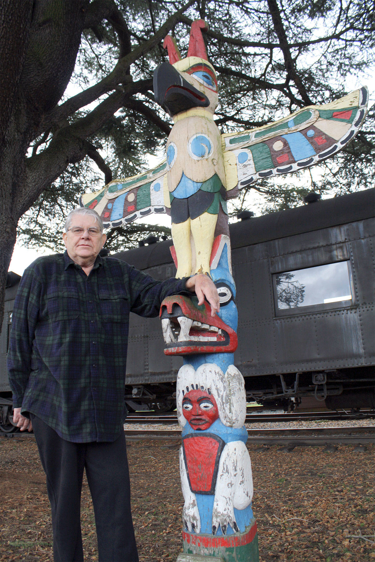 The memory of Snoqualmie city leader Charles Peterson, pictured here with the totem pole in downtown Snoqualmie, will be celebrated with a series of memorials unveiled in a dedication ceremony starting at 2 p.m., Sunday, Oct. 1, at Snoqualmie United Methodist Church. (File Photo)