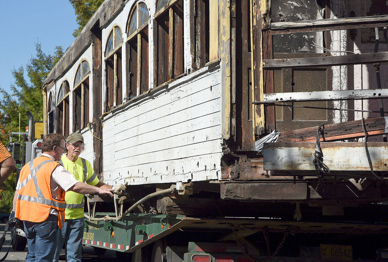 Museum director Richard Anderson and the driver who brought the car to Snoqualmie examine the car for places to reinforce the structure during the move onto the tracks. (Carol Ladwig/Staff Photo)