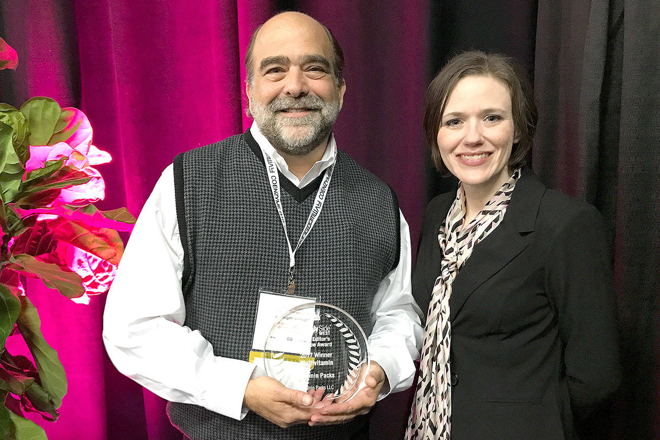 Vitamin Packs founder Jason Brown, left, accepts the Editor&rsquo;s Choice Award from Ginger Schlueter, assistant editor of Natural Products INSIDER. (Photo courtesy of Informa)