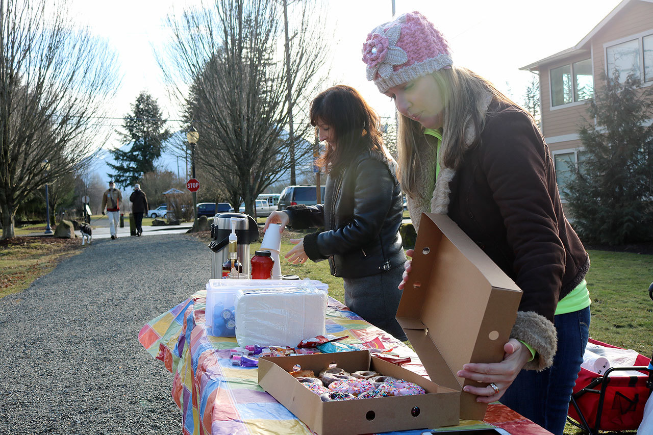 Kristen Zuray and Tonya Guinn set up a table of coffee and doughnuts for the Trail Youth project last January. The group aims to help connect teens and young adults who are struggling, with resources that can help them. (Evan Pappas/Staff Photo)