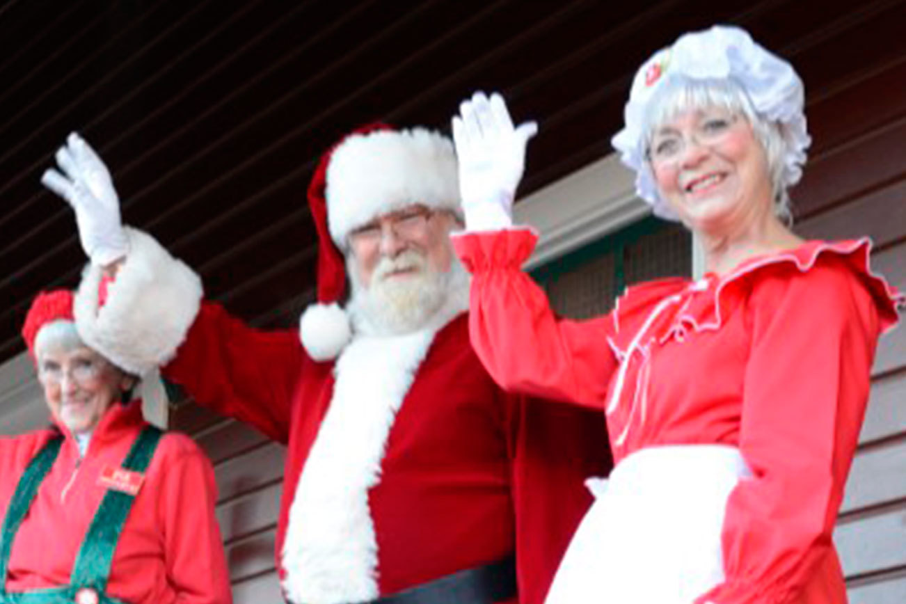 Courtesy Photo                                Santa and his helpers greet visitors on the Northwest Railway Museum’s Santa Train.