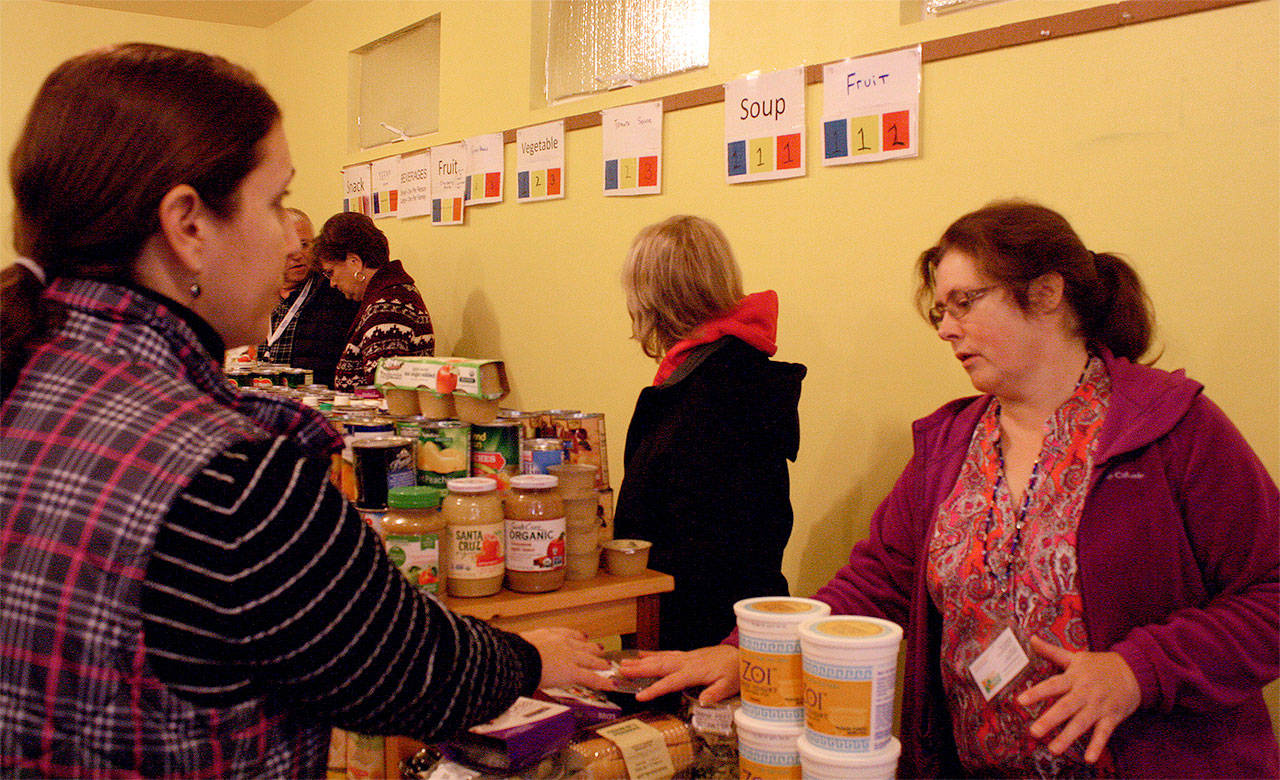 Food Bank volunteers and employees prepare the facility before the morning shift begins. (Evan Pappas/Staff Photo)