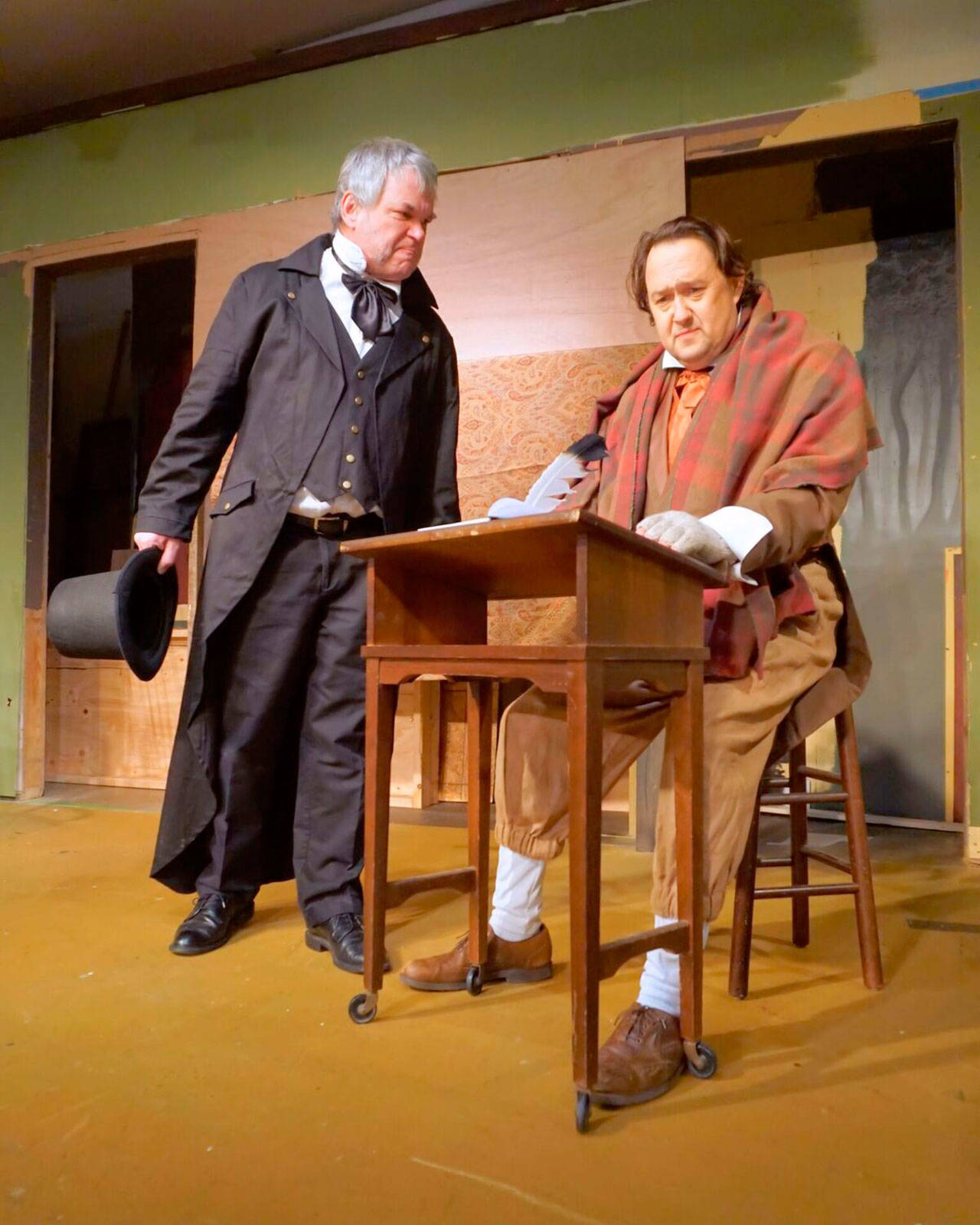 Scrooge, played by Tim Platt, reprimanding Bob Cratchit, played by Michael Murdock, when he asked for Christmas day off. (Courtesy Photo)