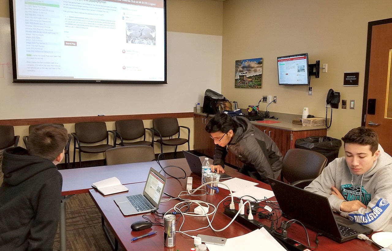 Members of the Mount Si High School Siber Defense club work on a school Capture the Flag competition in November. The team recently learned they placed fourth among the U.S. school teams competing in the international event. (Courtesy Photo)