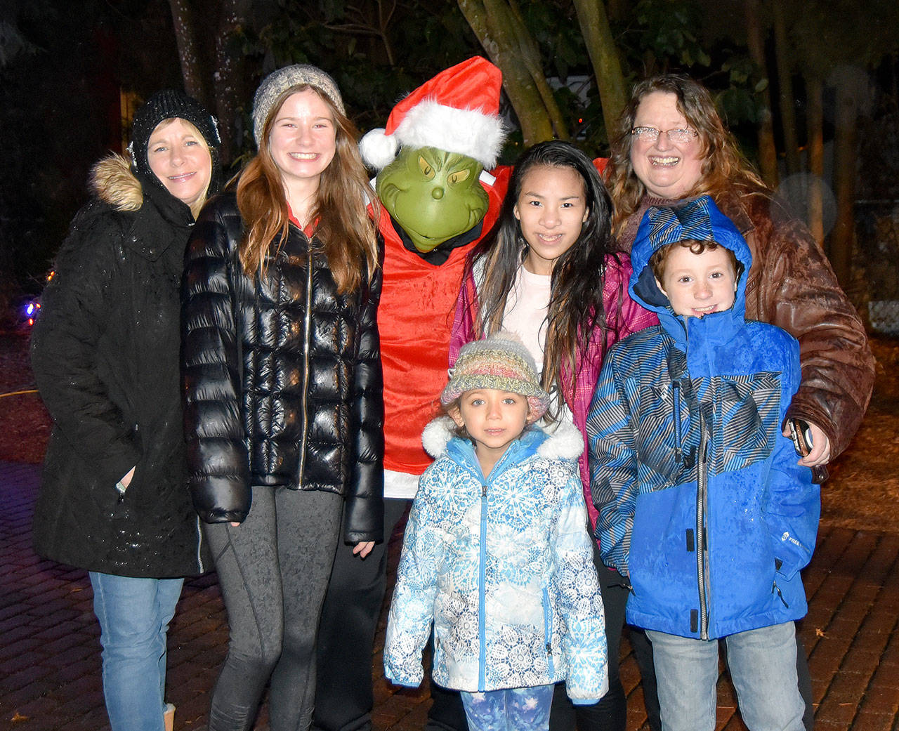 Sisters Pam and Susan Jones posed with their children and the Grinch at Snoqualmies holiday festival  an annual tradition for the two Snoqualmie Ridge families. (Carol Ladwig/Staff Photo)