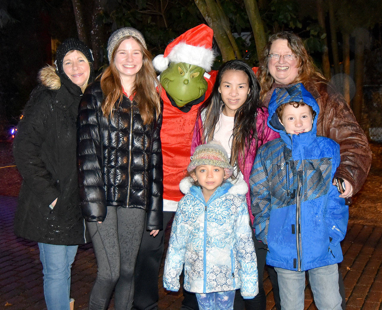 Sisters Pam and Susan Jones posed with their children and the Grinch at Snoqualmie’s holiday festival — an annual tradition for the two Snoqualmie Ridge families. (Carol Ladwig/Staff Photo)
